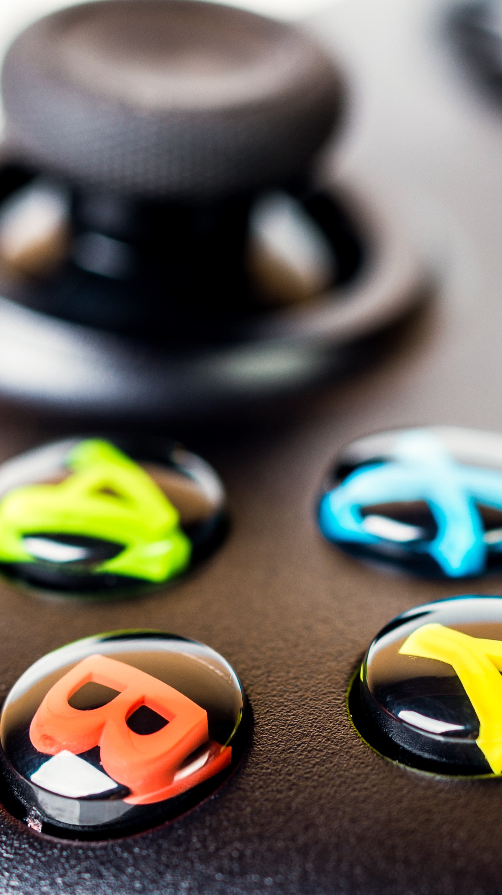 There are four buttons that are on a black surface (controller, gamepad, games, xbox, xbox one)