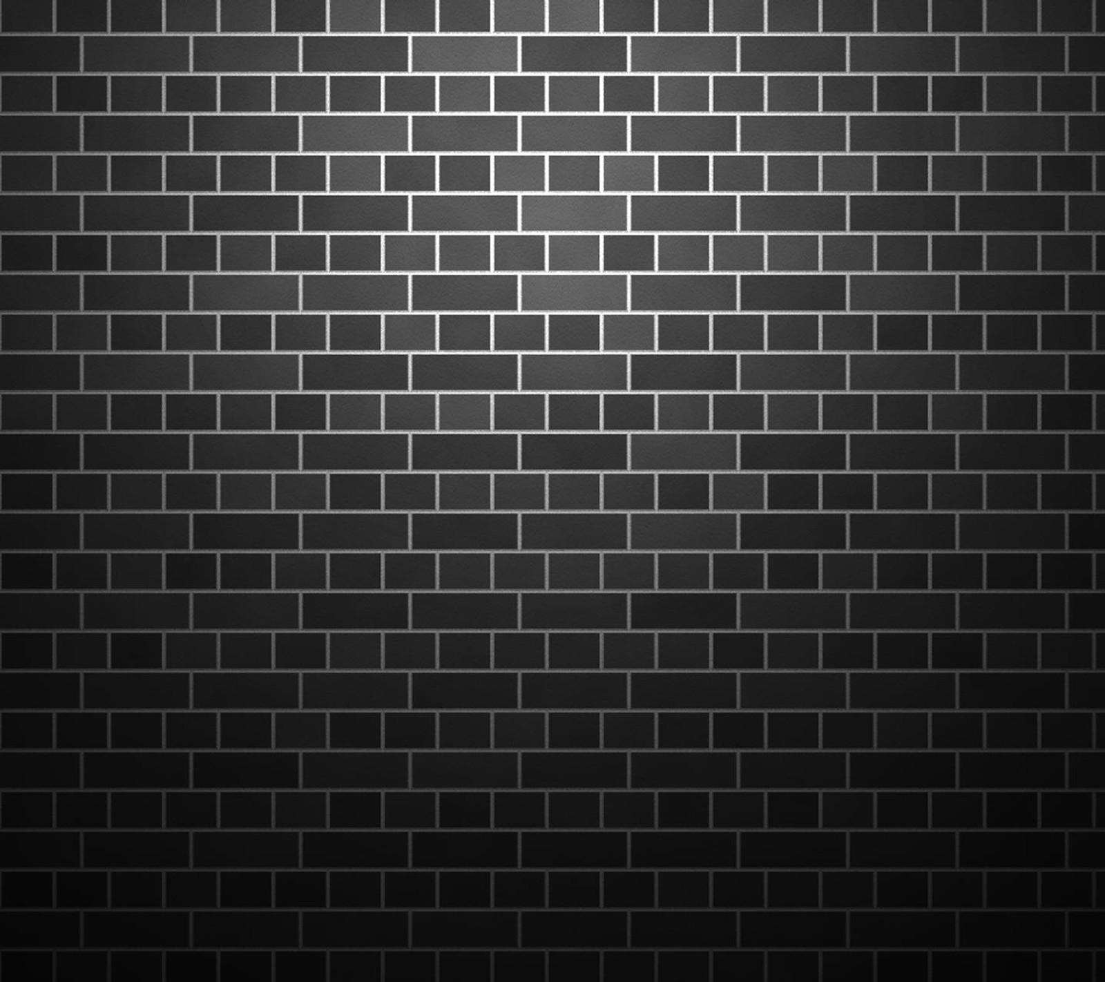 Un mur de briques noires avec une lumière qui brille dessus (noir, briques)