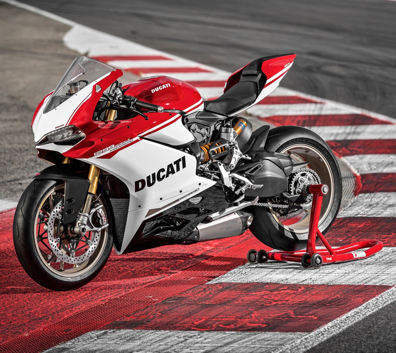 Ducati motorcycle on a race track with red and white stripes (black, ducati, italy, motorbike, red)