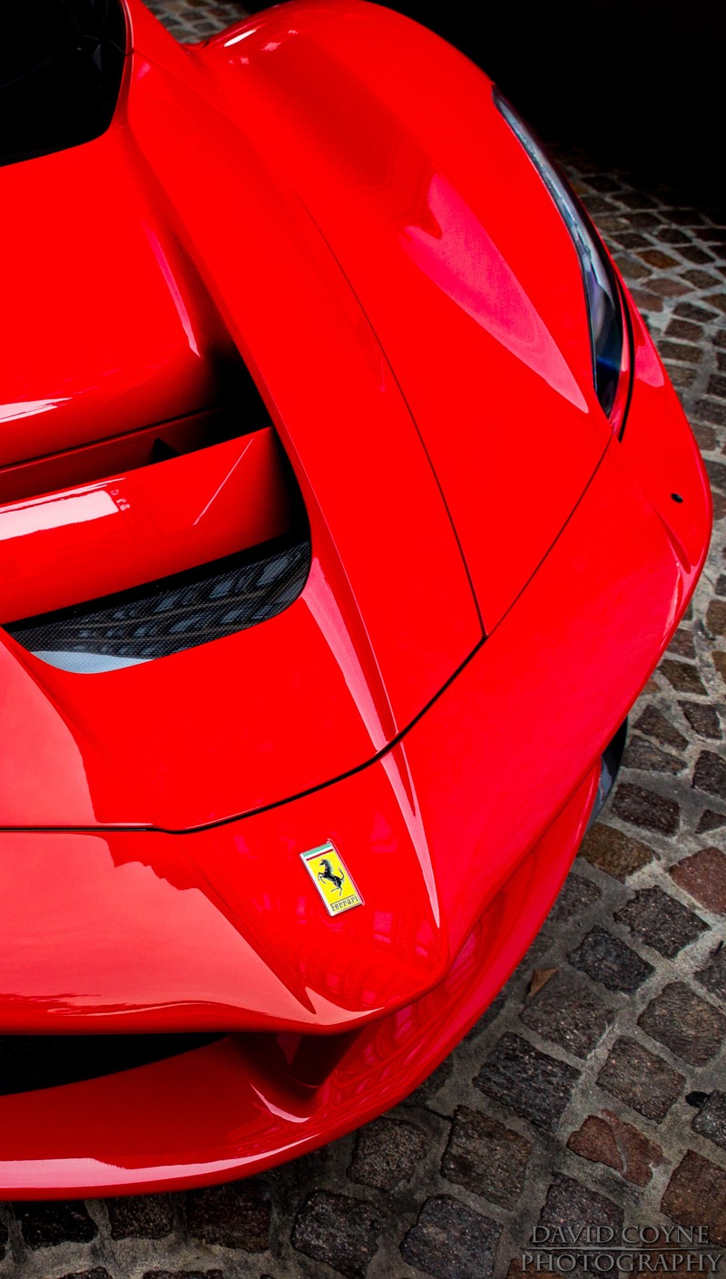 A close up of a red sports car parked on a cobblestone street (laferrari, red)