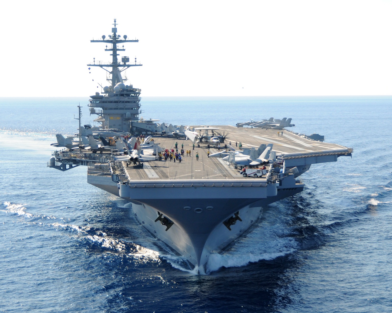 Arafed aircraft carrier on the water with people on board (united states navy, aircraft carrier, warship, ship, amphibious assault ship)