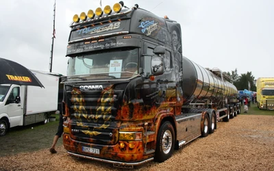 Custom Scania Truck with Elaborate Artwork and Tanker Trailer at Transport Event