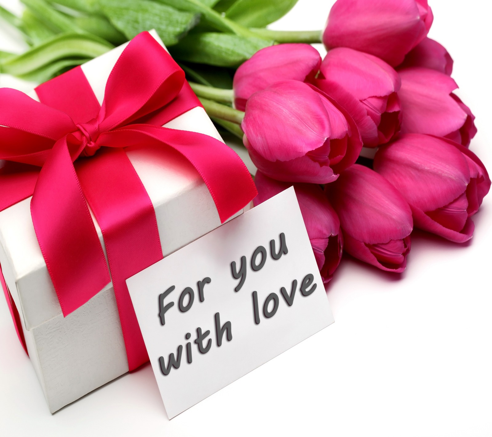 There is a white box with a pink ribbon and a pink flower (gift, love, tulips, with)