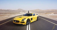 Yellow Mercedes-Benz SLS AMG parked on a deserted road, showcasing its sleek design against a vast desert backdrop.