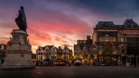 Dämmerung über einem historischen Stadtplatz mit Denkmal und charmanter Architektur