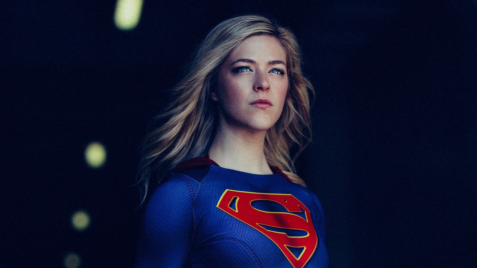 A woman in a superman costume standing in a dark room (supergirl, dc comics, comics, cosplay)