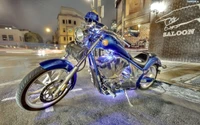 Custom Blue Bobber Motorcycle at Night in Urban Setting