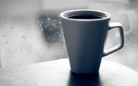 Serene Coffee Moments: A Ceramic Mug on a Rainy Day