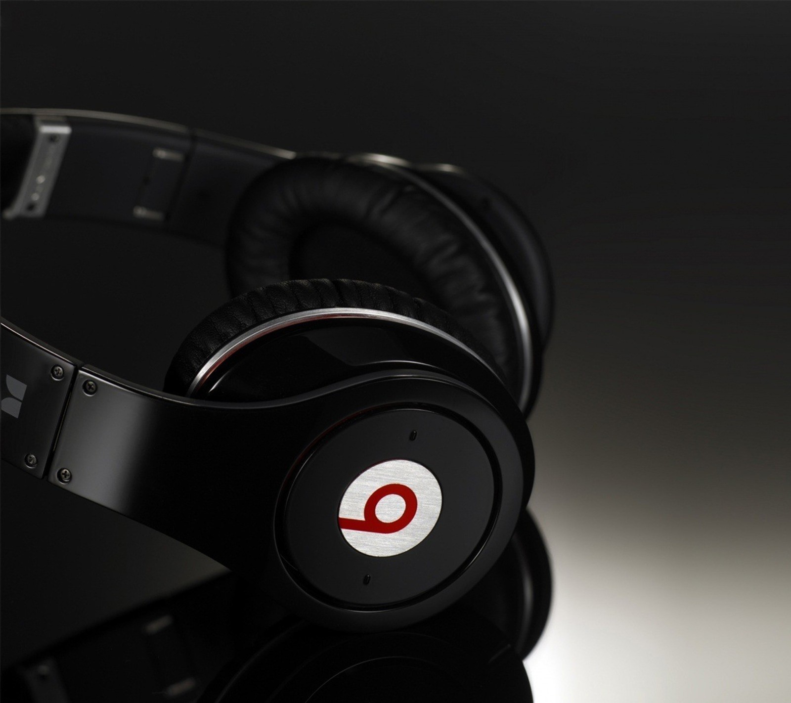 A close up of a pair of headphones with a black background (android, beats, black, evo, kbrn)