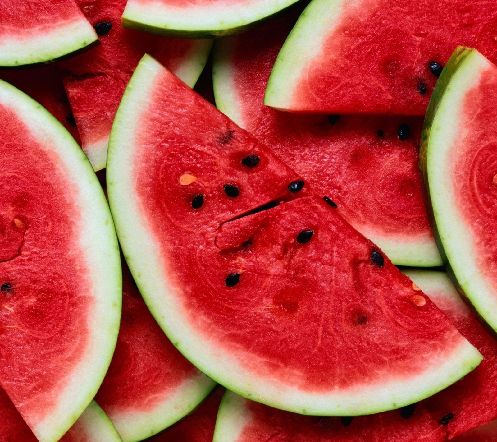 Slices of watermelon are arranged in a pattern on a table (food, watermelon)