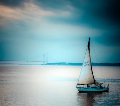 Solitary Sailboat on a Tranquil Blue Horizon