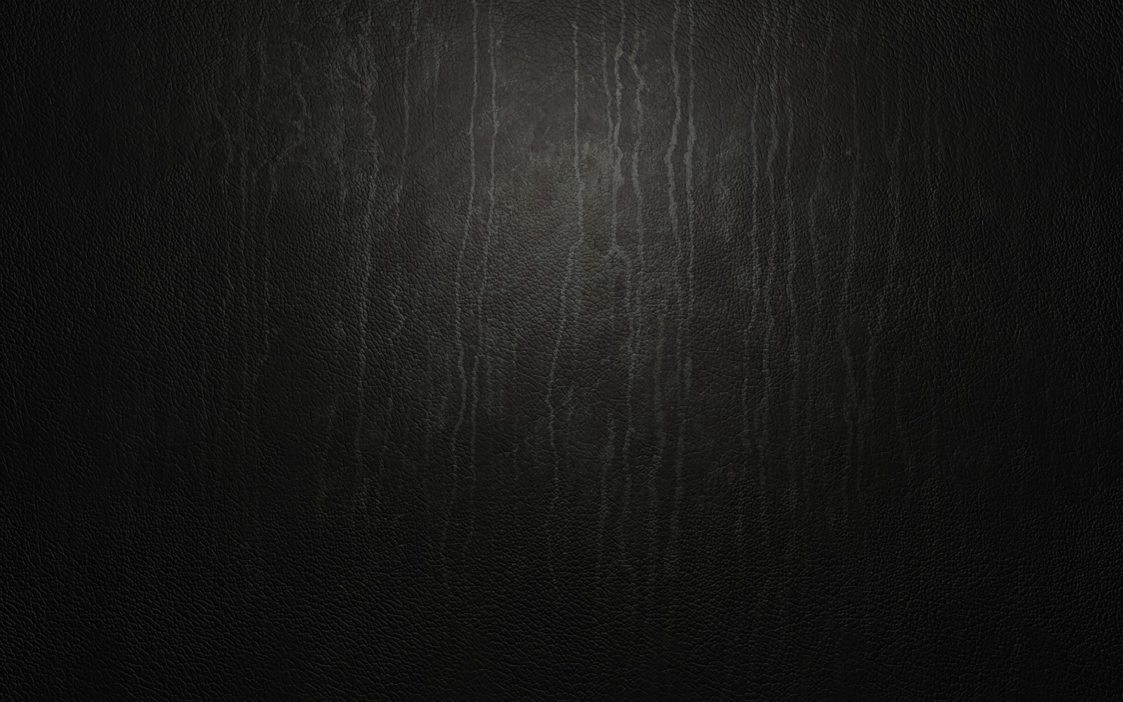 A close up of a black leather surface with a light shining through it (black, darkness, atmosphere, monochrome, black and white)