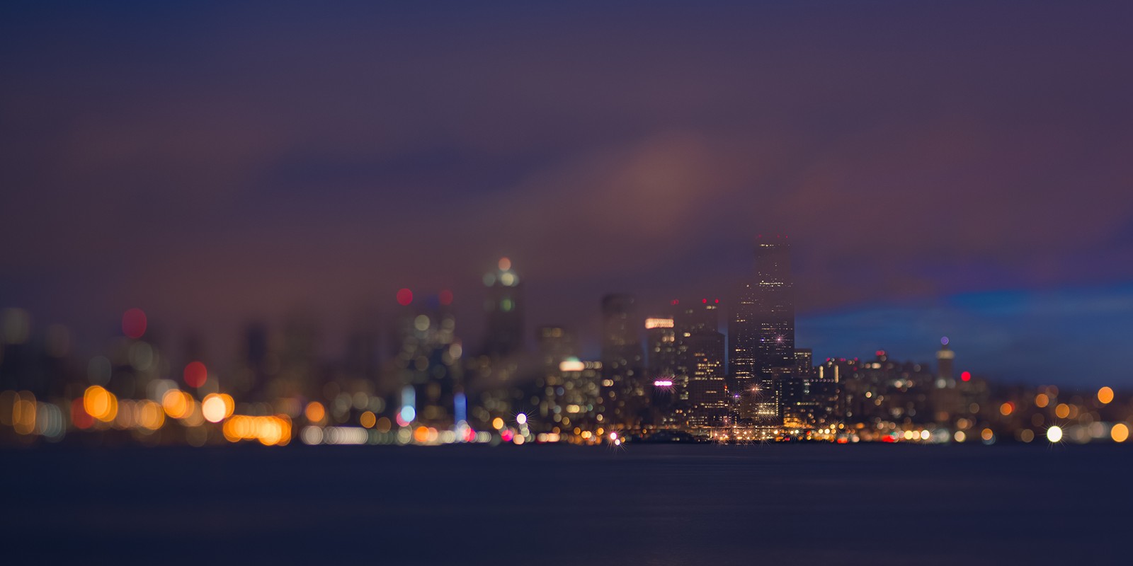 Uma vista do horizonte da cidade à noite com um barco na água (paisagem urbana, seattle, noite, horizonte, cidade)