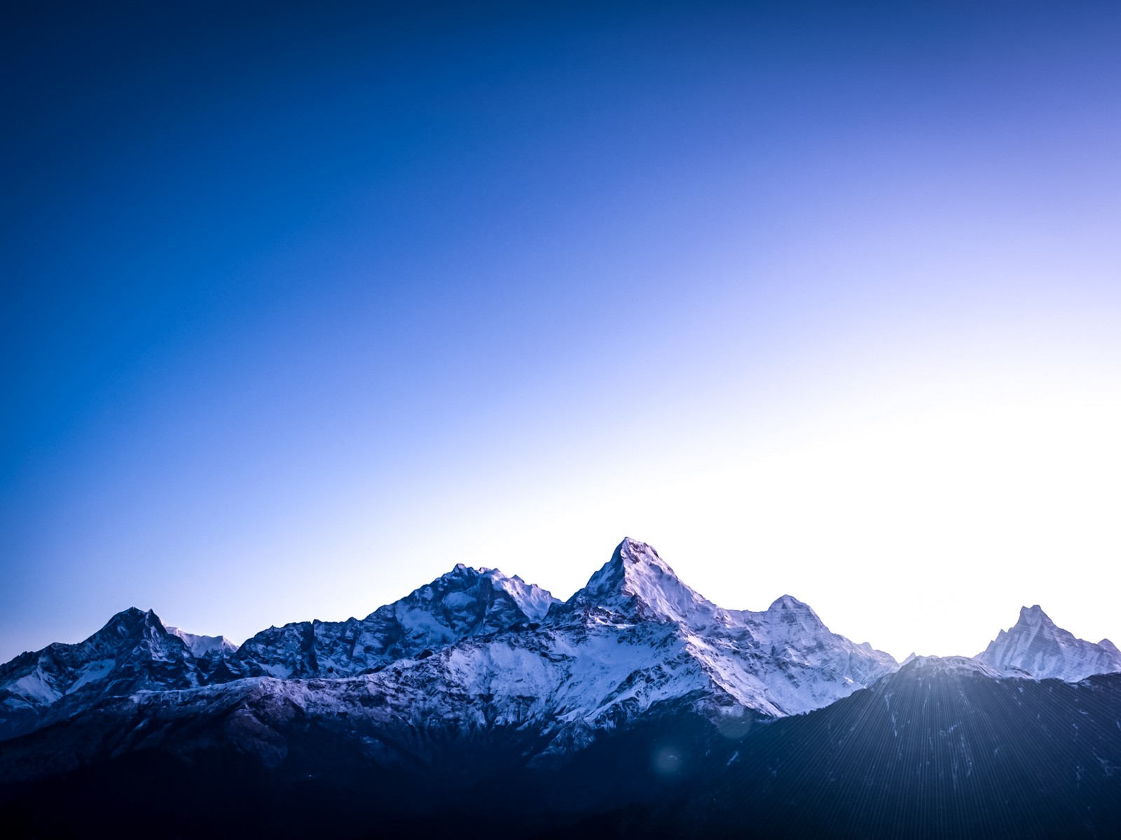 Mountains with snow on them and a blue sky in the background (annapurna, mountain, atmosphere, natural landscape, slope)