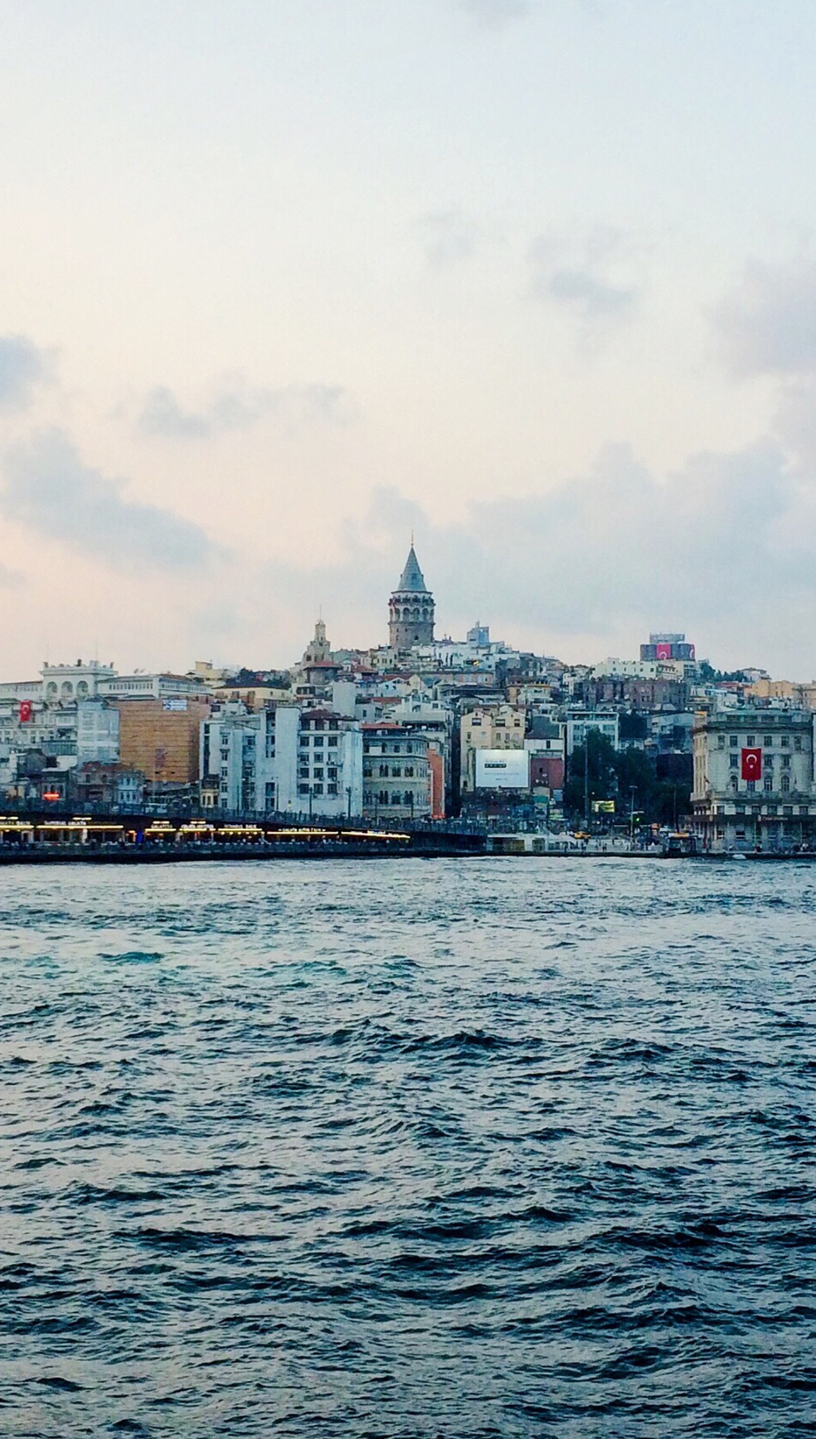 There is a large body of water with a city in the background (eminonu, galata, galata kulesi, istanbul, sirkeci)