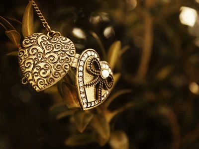 Antique Gold Heart-Shaped Jewelry Adorned with Gems and Intricate Designs