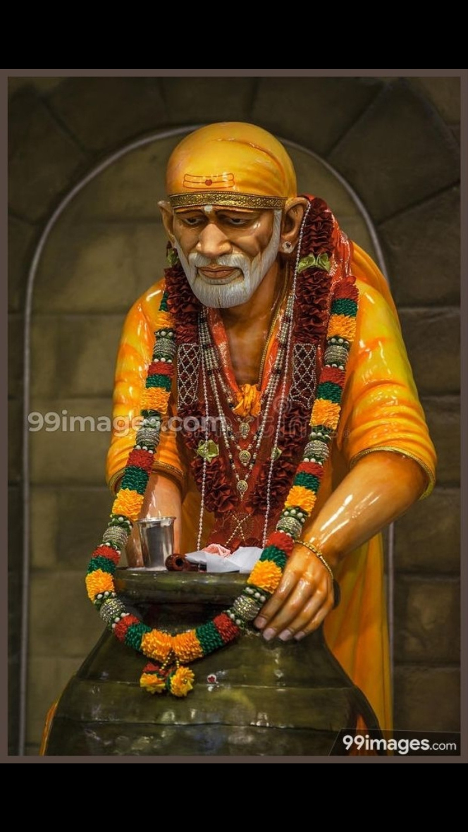 A statue of a man with a bowl of food in his hand (akshayapatra, sai baba)