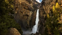 Yosemite Falls: Majestic Waterfall Surrounded by Rugged Cliffs and Lush Vegetation