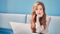 Tzuyu from TWICE: A Moment of Reflection with a Laptop