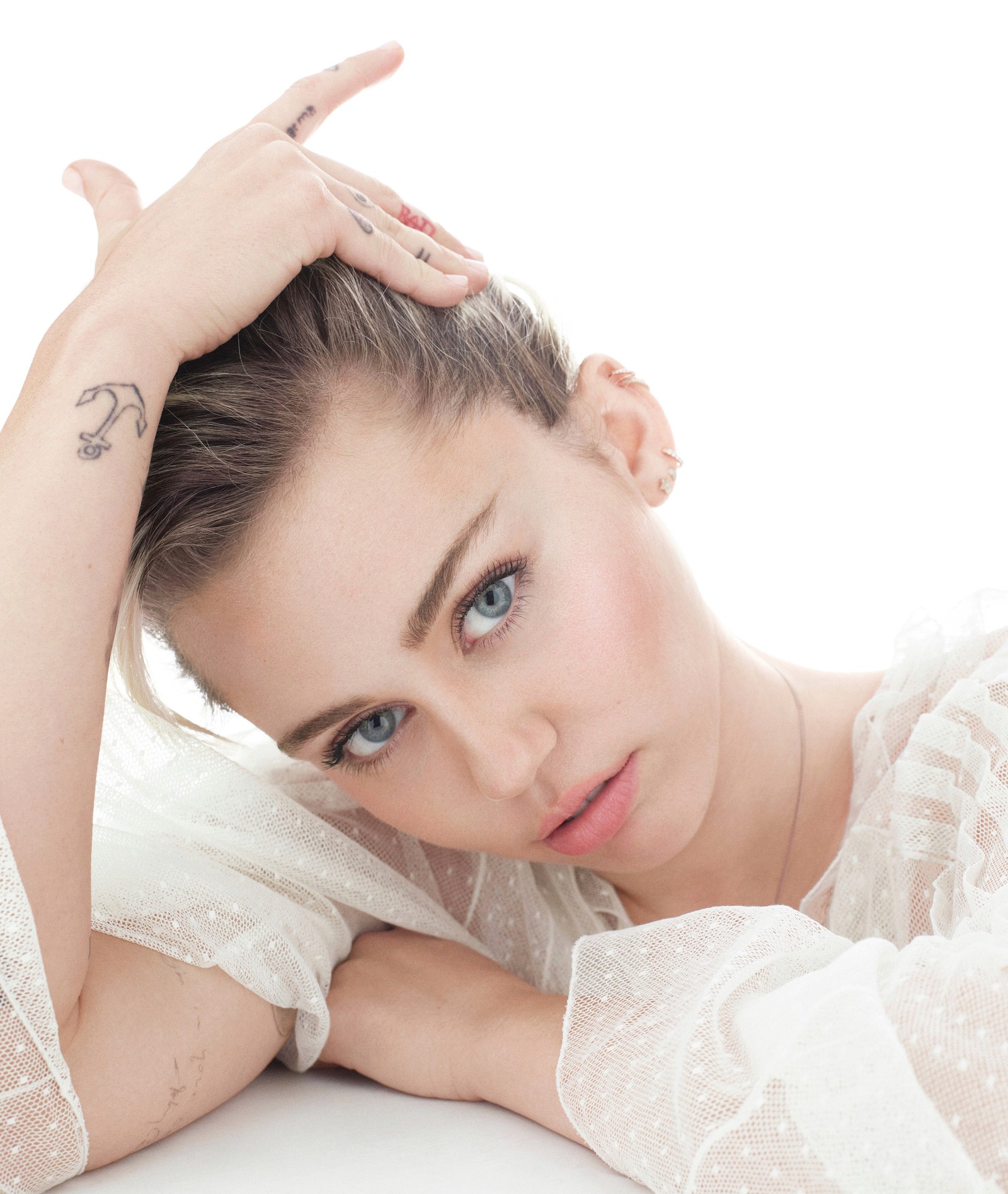 Arafed woman with a tattoo on her arm and a white dress (miley cyrus, singer, white background, people, 4k wallpaper)