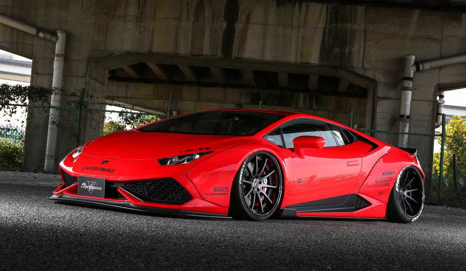 A red lamb sports car parked under a bridge (car, lamborghini aventador, lamborghini, lamborghini murcilago, body kit)