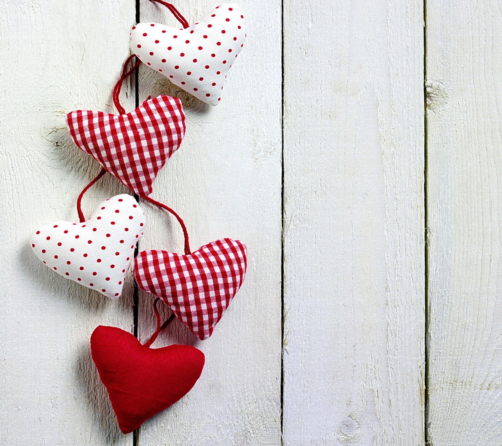 Trois cœurs suspendus à une corde sur un mur en bois blanc (cœurs, amour, romantique)