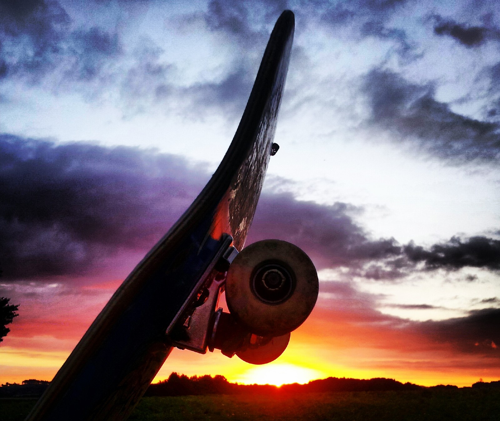 Arafed view of a skateboard with a sunset in the background (art, love, nature, prod, scenery)