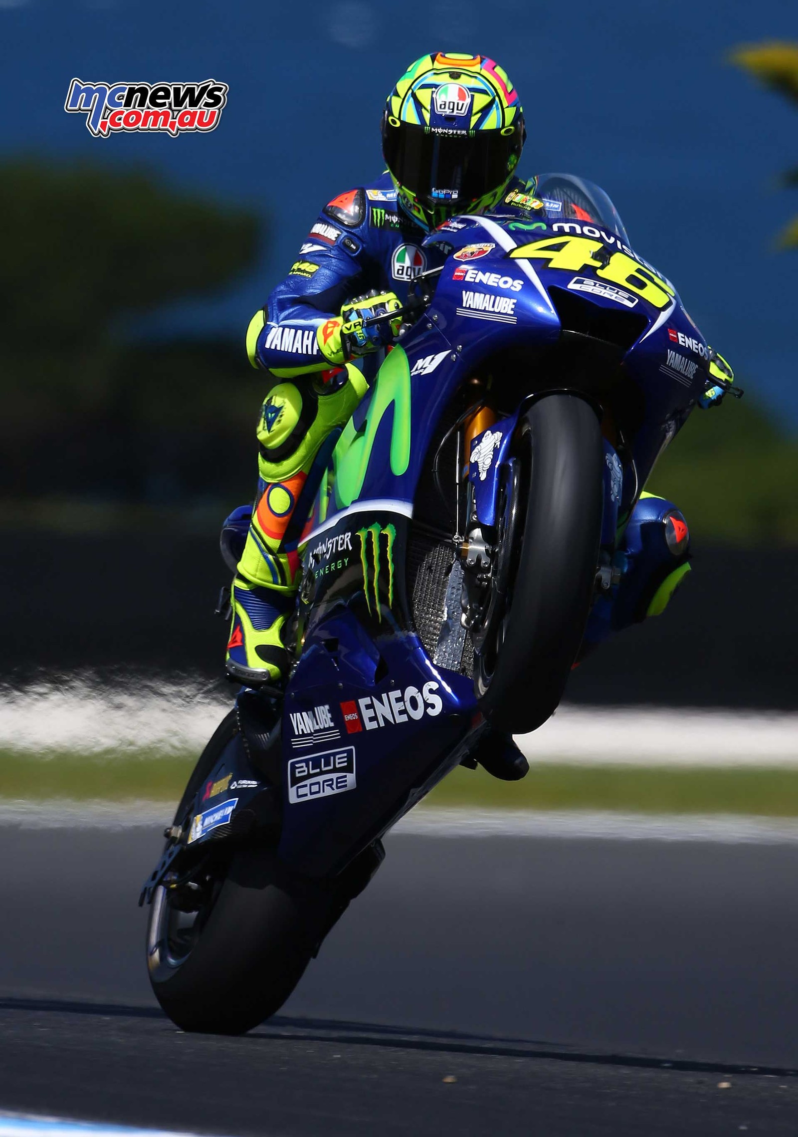 Arafed motorcycle rider in a blue and yellow outfit riding a motorcycle (vr46, valentino rossi, rossi, the doctor)