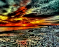 Vibrant Sunset Over a Rocky Beach Coastline