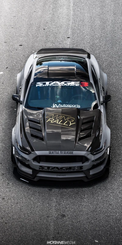 Customized Ford Mustang with aggressive styling and racing decals.