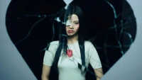 Yunjin from LE SSERAFIM in a striking "Bloody Rose" concept, framed by a heart-shaped cracked mirror.