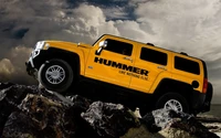 Yellow Hummer Pickup Truck Off-Roading on Rocky Terrain