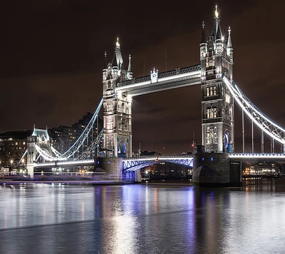 Illuminated Tower Bridge Reflected on the Thames at Night