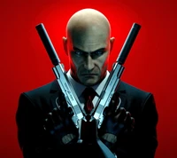 A striking portrait of a bald man in a suit, holding silver handguns against a bold red background, exuding intensity and focus.