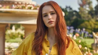 Red-haired Model in Yellow Shirt Surrounded by Lush Garden