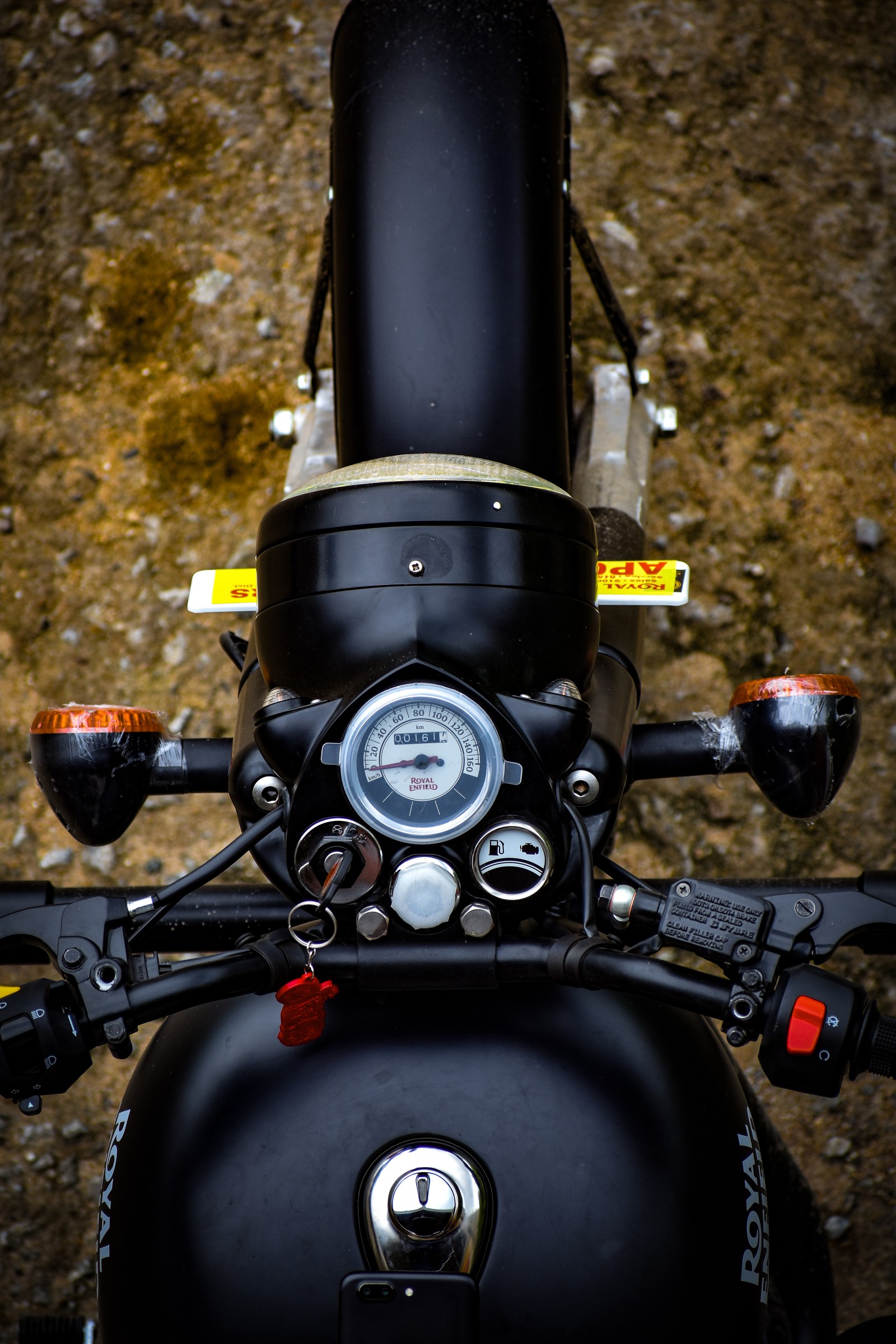 There is a close up of a motorcycle with a black handlebar (black, bullet, enfield, royal enfield)