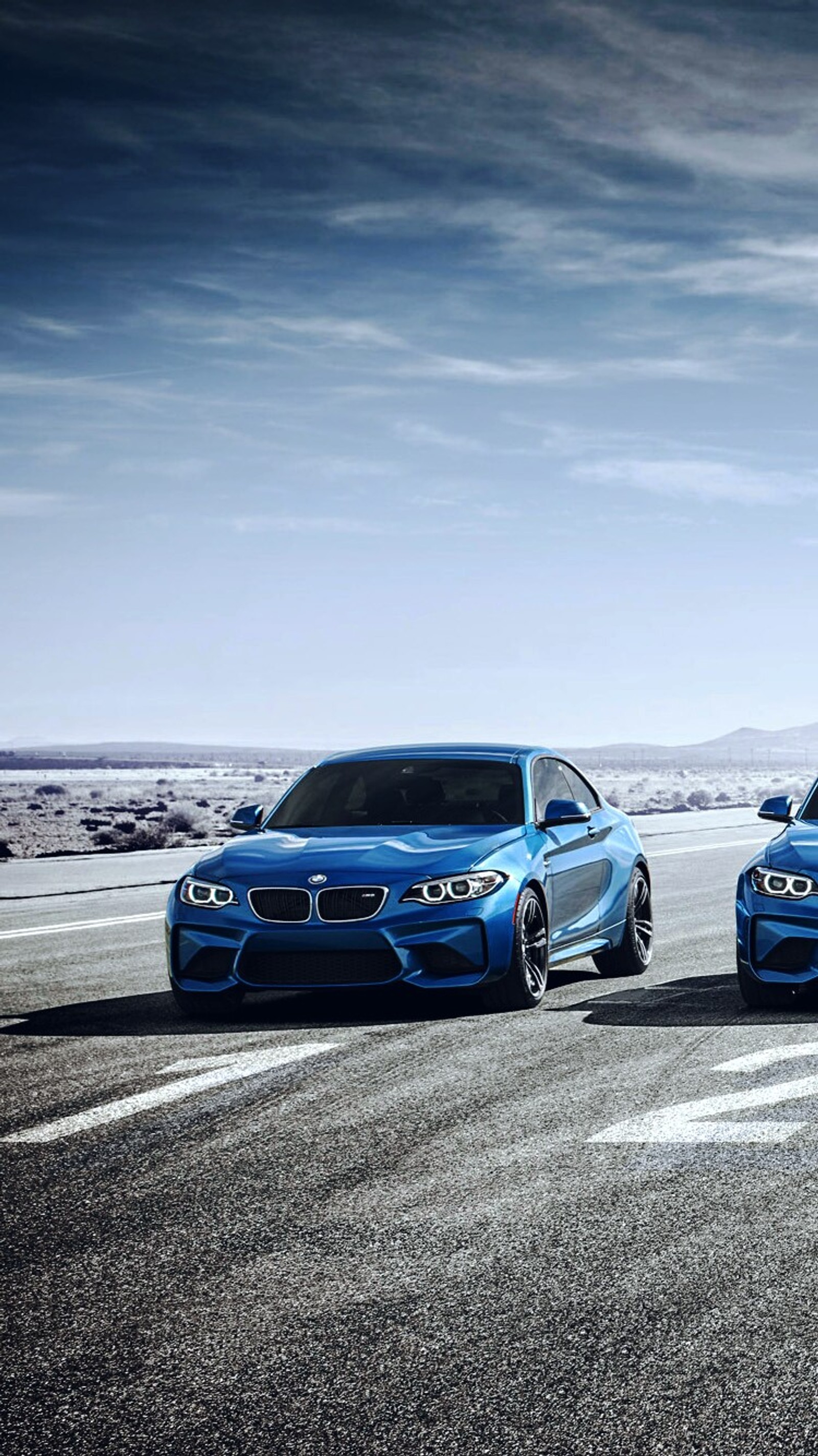 Two blue cars are parked on a road with a cloudy sky (auto, blue, bmw, car, coupe)