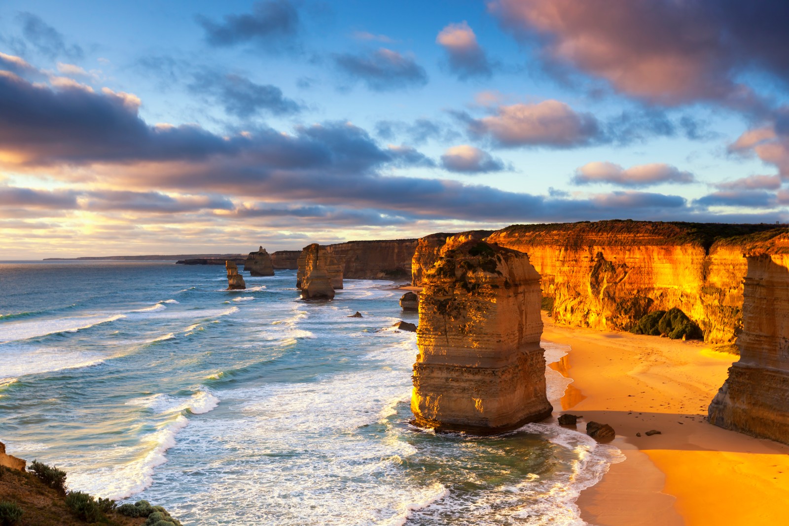 A view of the twelve apostless at sunset from the cliffs of the great ocean road (coast, sea, cliff, shore, ocean)