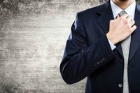 Elegant Formal Wear: A Gentleman Adjusting His Necktie