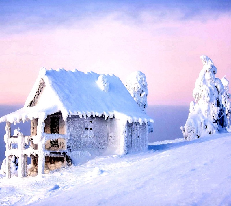 Snowy cabin on a mountain with a pink sky in the background (winter)