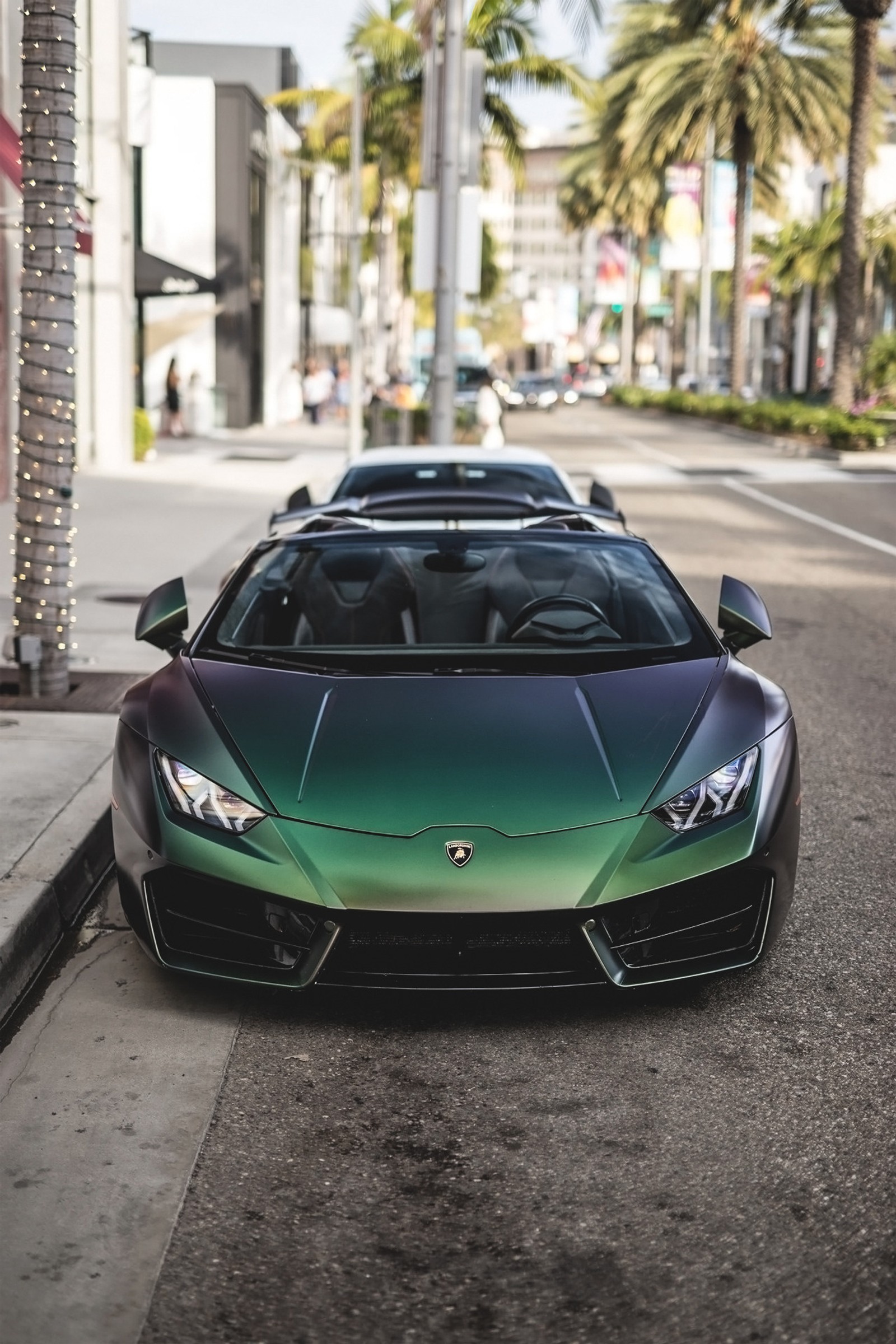 A close up of a green and black sports car parked on a street (4k, araba, car, cars, hd)