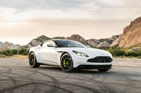 2020 Aston Martin DB11 AMR in a scenic landscape, showcasing its sleek design and powerful stance.