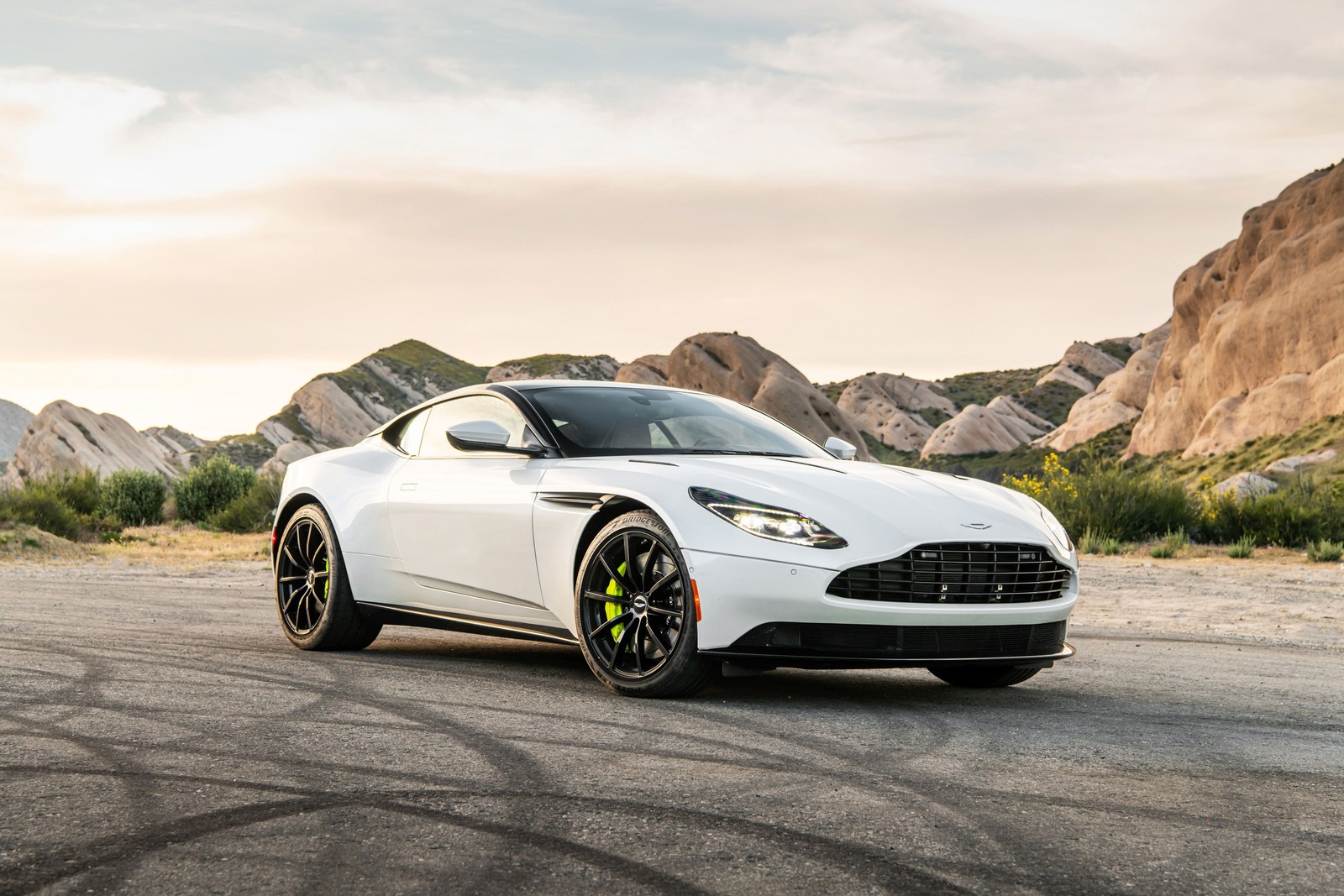 A white aston vantage is driving on a road in the desert (aston martin db11 amr, 2020, cars, 4k wallpaper)