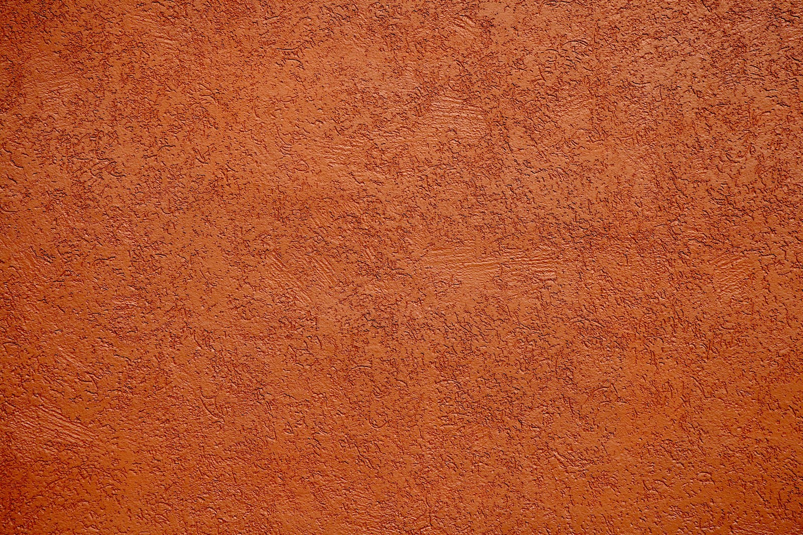 A close up of a tennis ball on a clay court (texture, paint, wall, design, wood stain)