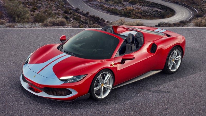 Красный спортивный автомобиль ferrari едет по дороге рядом с горой (ферари 296 гтс асетто фиорано, 5k, спортивные автомобили, 2022, 8k)