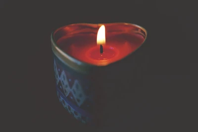 Heart-Shaped Candle Illuminating a Dark Space