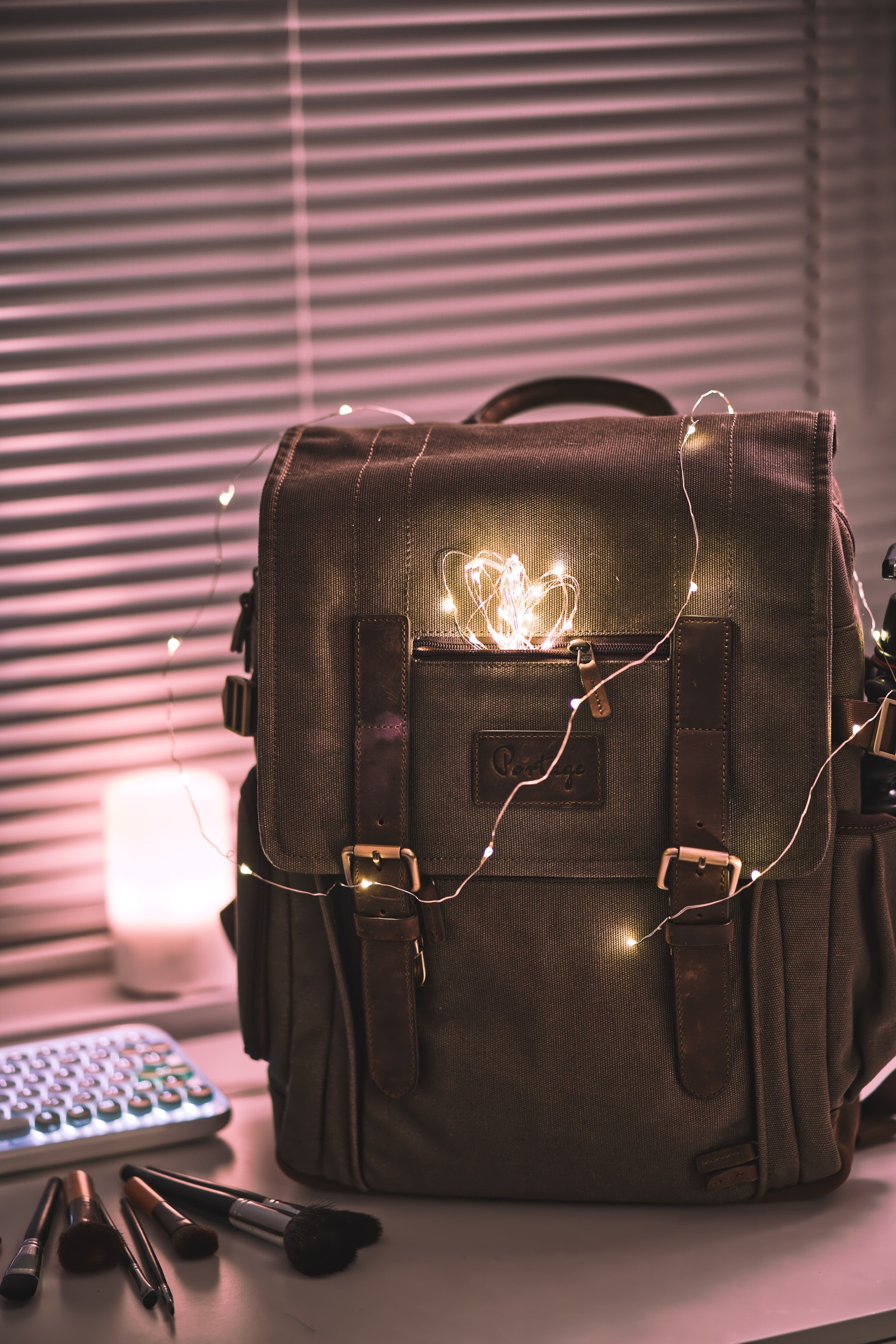 Eine braune tasche mit licht steht auf einem schreibtisch (messenger bag, tasche, modeaccessoire, leder, handtasche)