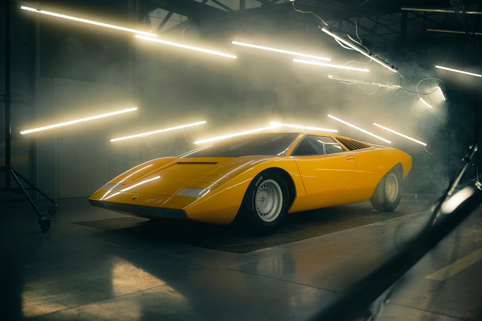 A close up of a yellow car in a garage with lights (lamborghini countach lp500, 8k, 2021, 5k, cars)