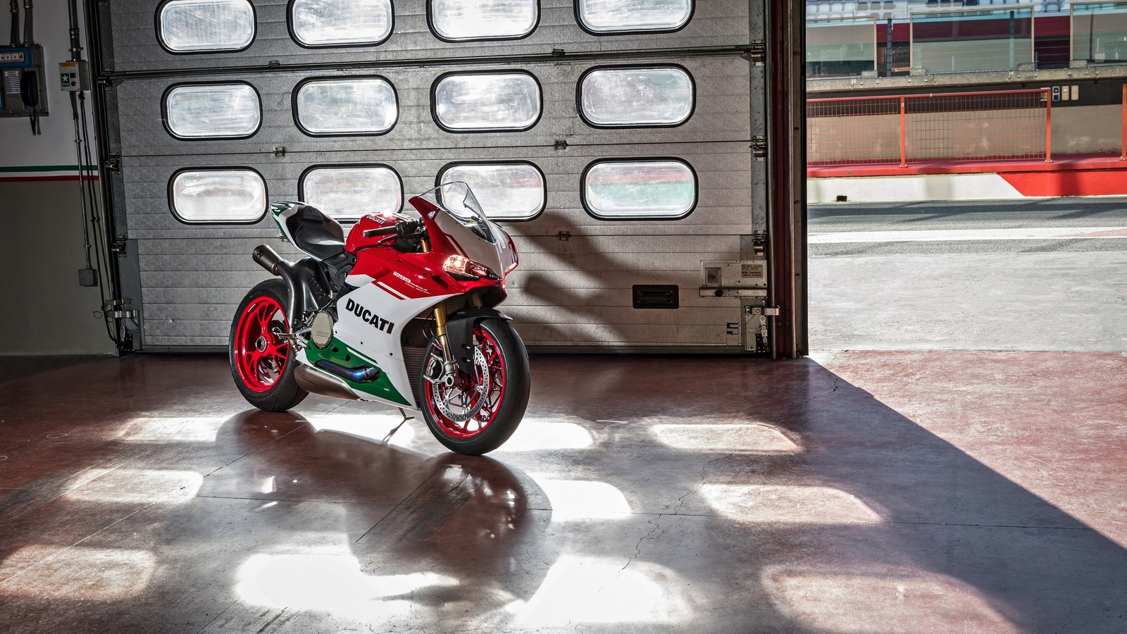 Arafed motorcycle parked in front of a garage door with a window (ducati, green, italy, motorbike, red)