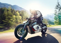 BMW Vision DC Roadster: Futuristic Electric Motorcycle in Motion Amidst Scenic Landscape